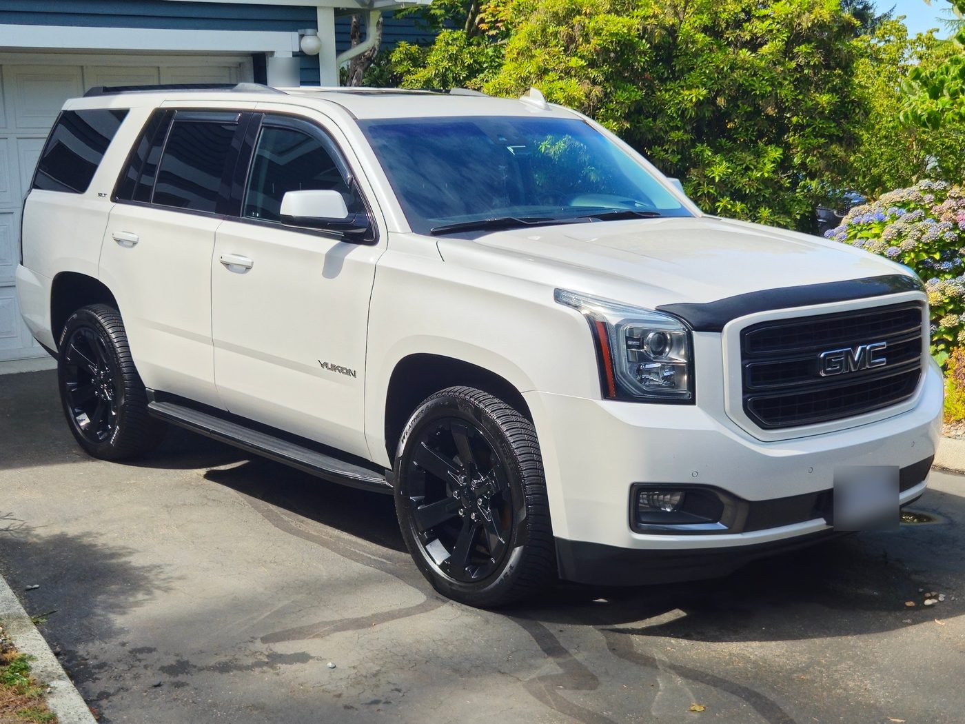 White GMC Yukon with black wheels, clean after a mobile detail by Vantique Detailing