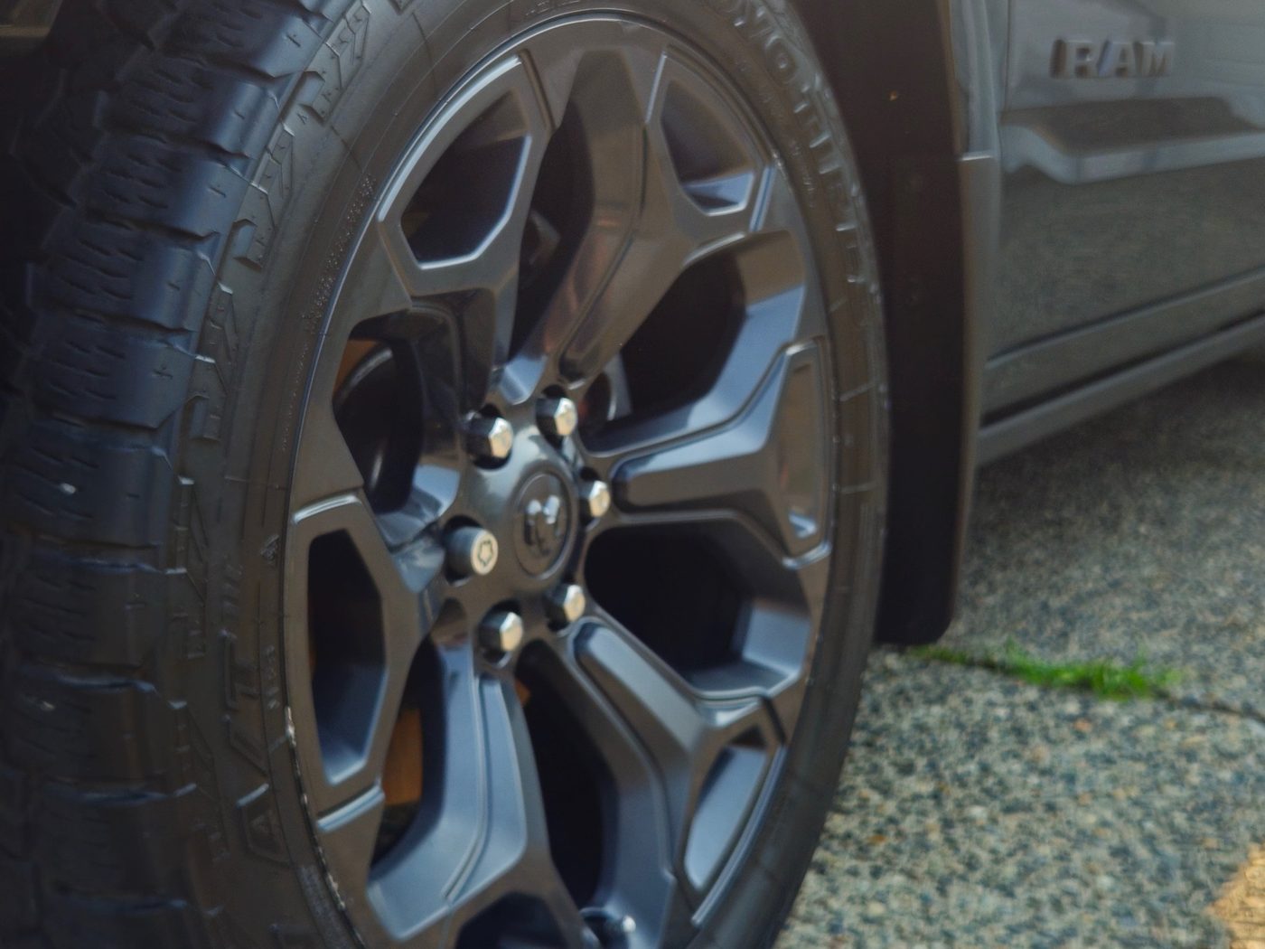 Clean black wheel and dressed tire on a Ram truck after detailing by Vantique Detailing